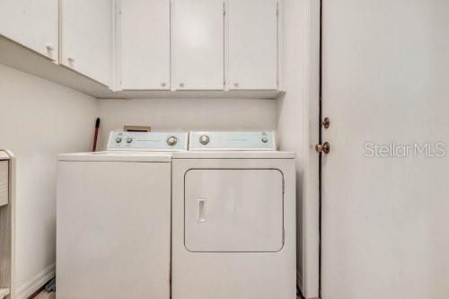 6435 Borg St, Leesburg, FL 34748 - washroom with washer and clothes dryer and cabinet space