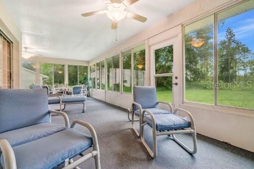 sunroom / solarium with ceiling fan