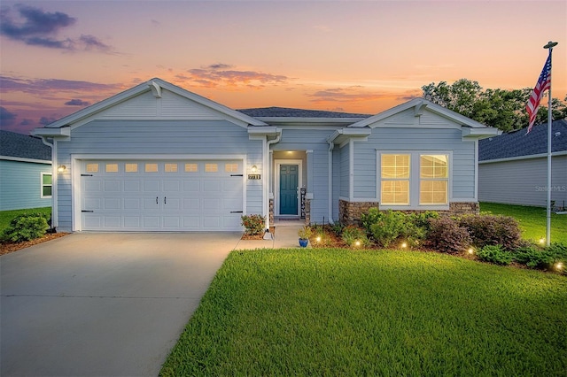 view of front of property with a yard and a garage