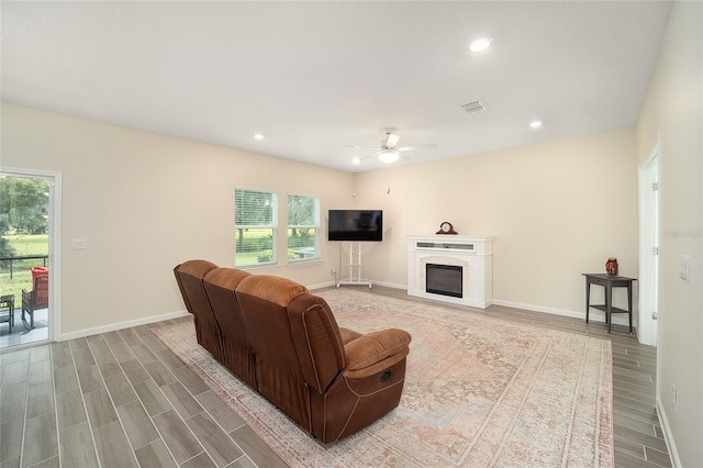 living room featuring ceiling fan and a healthy amount of sunlight