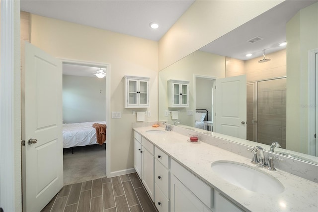 bathroom with an enclosed shower, vanity, and ceiling fan