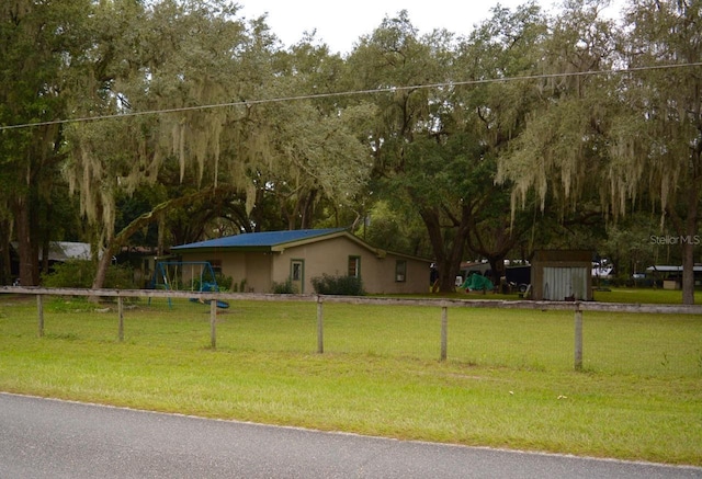 view of yard with a playground and a shed