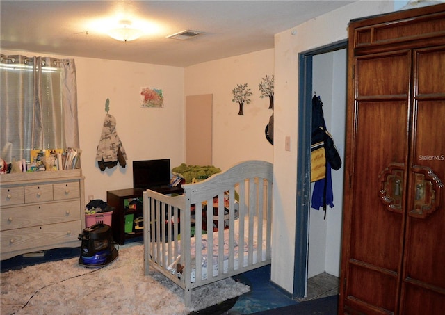 bedroom featuring a crib