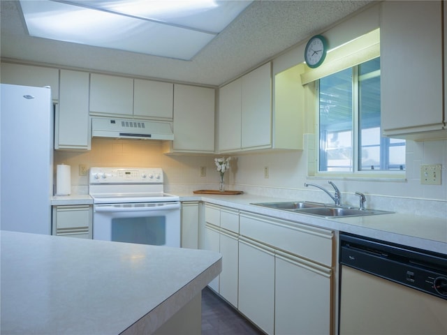 kitchen featuring extractor fan, sink, white cabinets, and white appliances