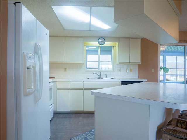 kitchen with white cabinetry, white fridge with ice dispenser, sink, and backsplash