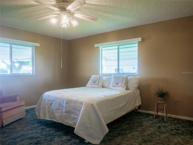 carpeted bedroom featuring a textured ceiling and ceiling fan