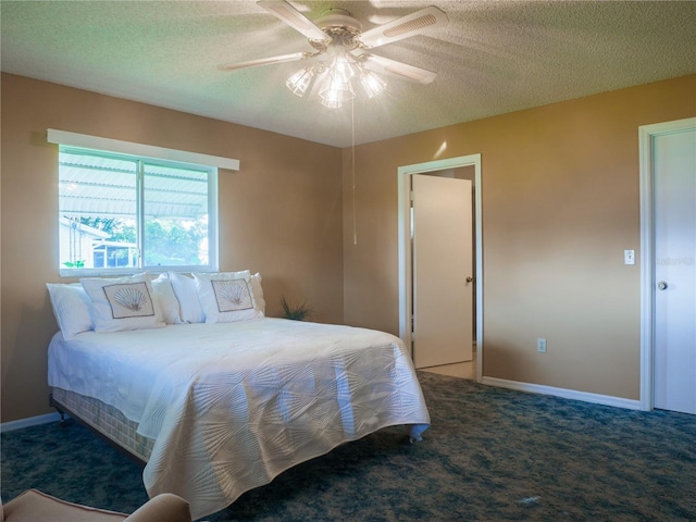 bedroom featuring a textured ceiling, ceiling fan, and carpet flooring