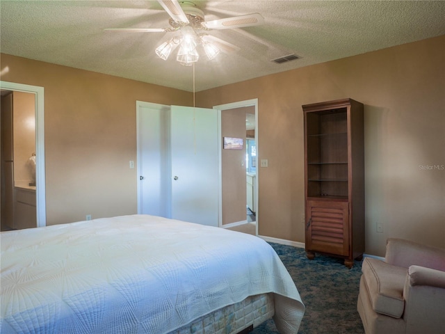 carpeted bedroom featuring connected bathroom, a textured ceiling, and ceiling fan