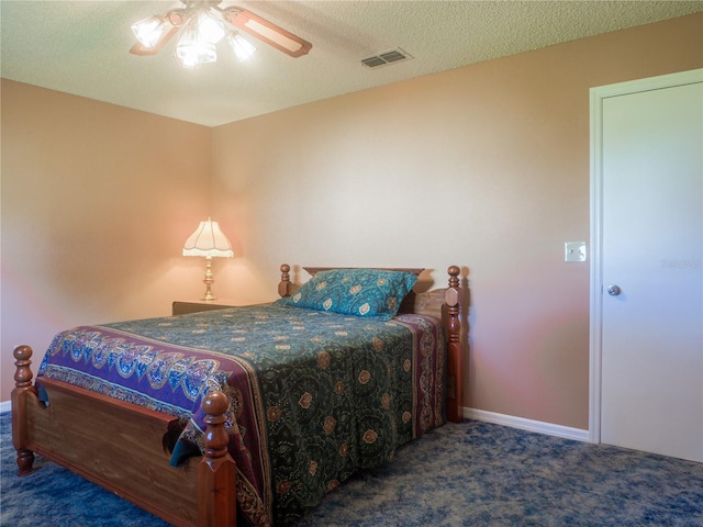 bedroom with dark carpet, a textured ceiling, and ceiling fan