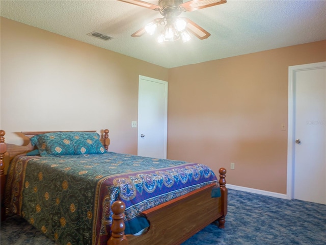 bedroom with ceiling fan, a textured ceiling, and dark colored carpet