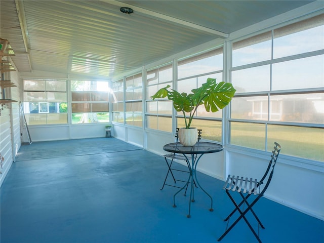 unfurnished sunroom featuring vaulted ceiling