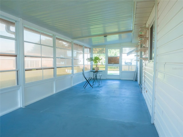 unfurnished sunroom featuring lofted ceiling