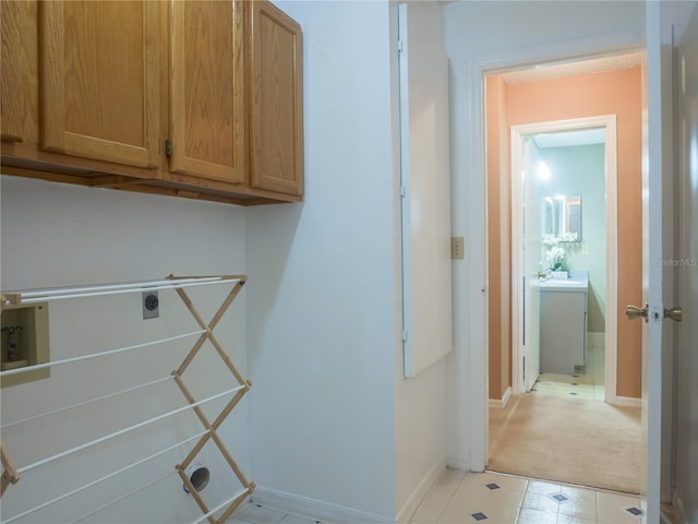 laundry room with cabinets and electric dryer hookup