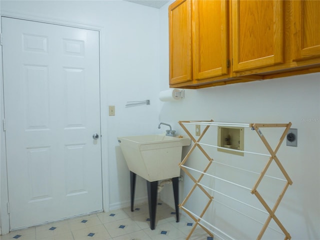 laundry area with cabinets, hookup for a washing machine, and hookup for an electric dryer