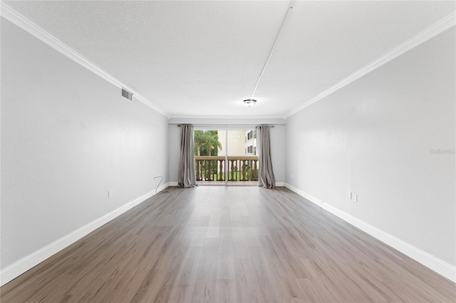 unfurnished room with crown molding, a textured ceiling, and light wood-type flooring