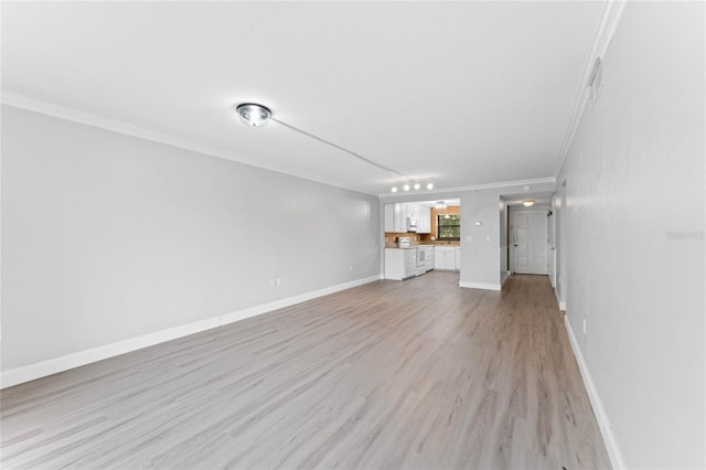 unfurnished living room featuring crown molding and light hardwood / wood-style flooring