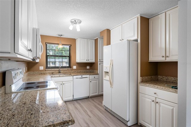 kitchen with white cabinetry, sink, white appliances, and decorative light fixtures