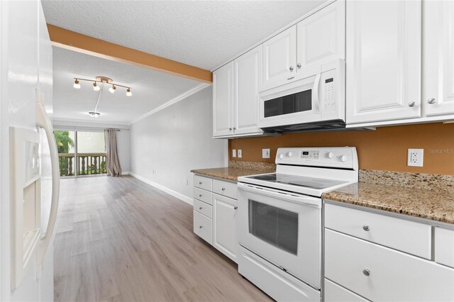 kitchen featuring white cabinetry, light stone counters, white appliances, and a textured ceiling