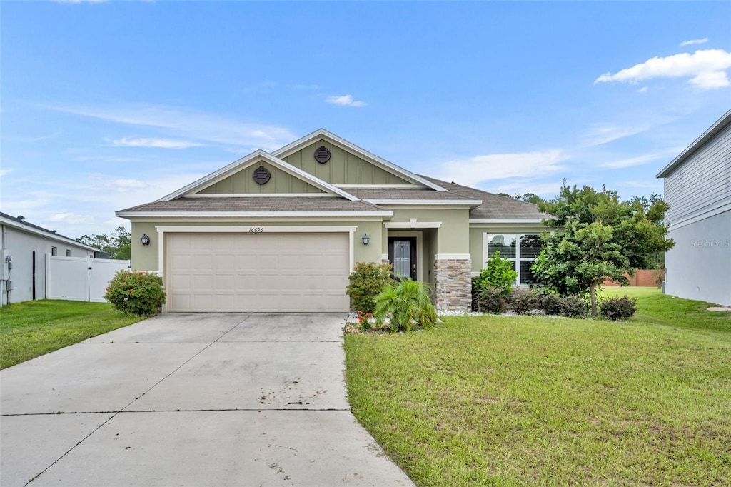 view of front of home with a garage and a front yard