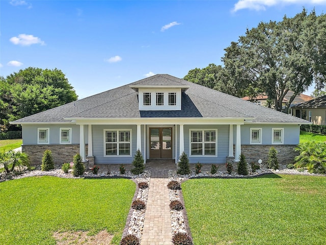 view of front facade with a front yard and french doors