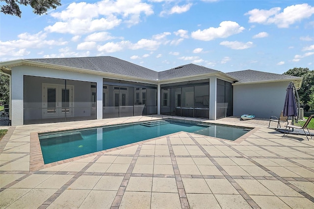 view of pool with a sunroom and a patio area