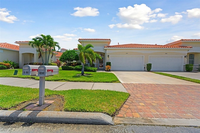 mediterranean / spanish-style home featuring a garage and a front yard