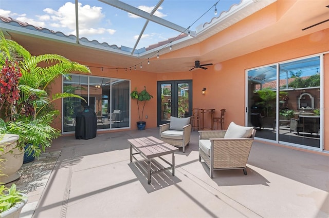 view of patio with a lanai, outdoor lounge area, and ceiling fan