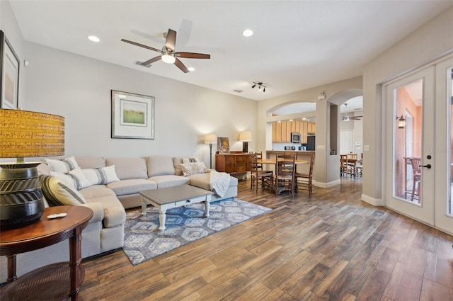 living room with hardwood / wood-style floors, french doors, and ceiling fan