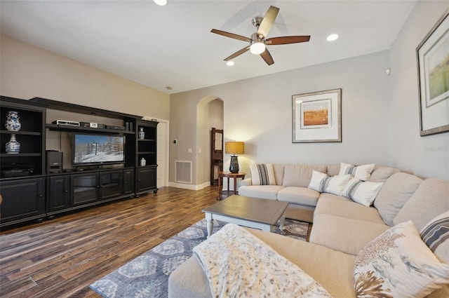 living room featuring dark hardwood / wood-style floors and ceiling fan