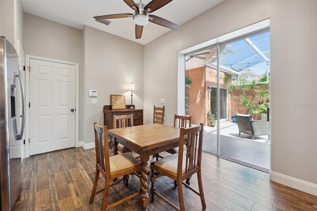 dining room with ceiling fan and dark hardwood / wood-style flooring