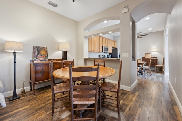 dining area featuring dark wood-type flooring and ceiling fan