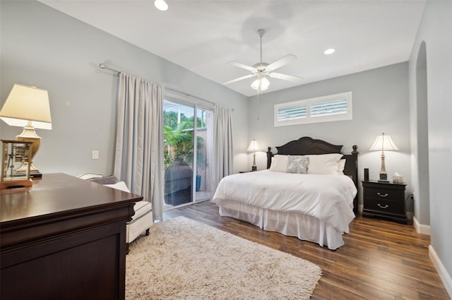 bedroom featuring a baseboard radiator, dark hardwood / wood-style floors, and access to outside