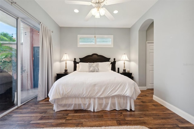 bedroom with access to exterior and dark wood-type flooring