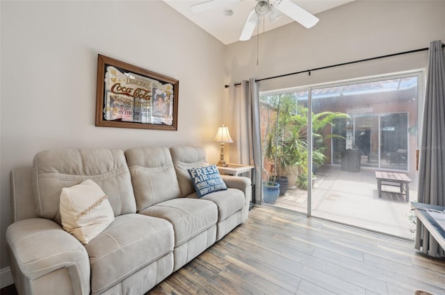 living room with wood-type flooring and ceiling fan