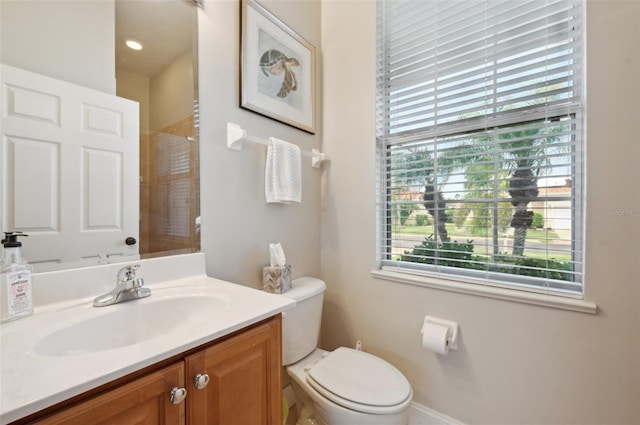 bathroom with vanity, toilet, and walk in shower