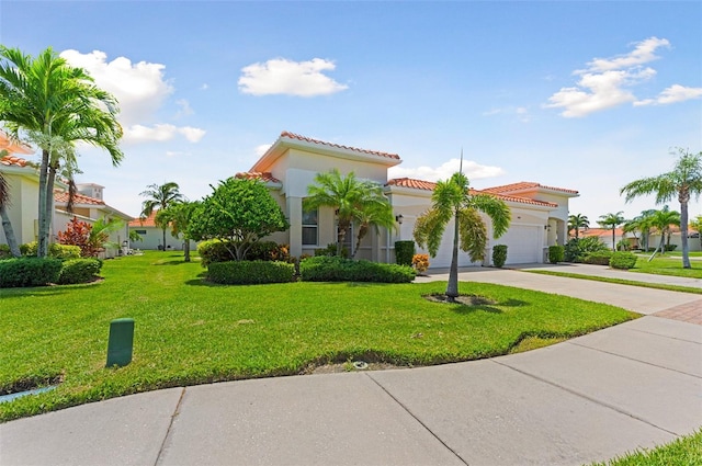 mediterranean / spanish home with a garage and a front yard