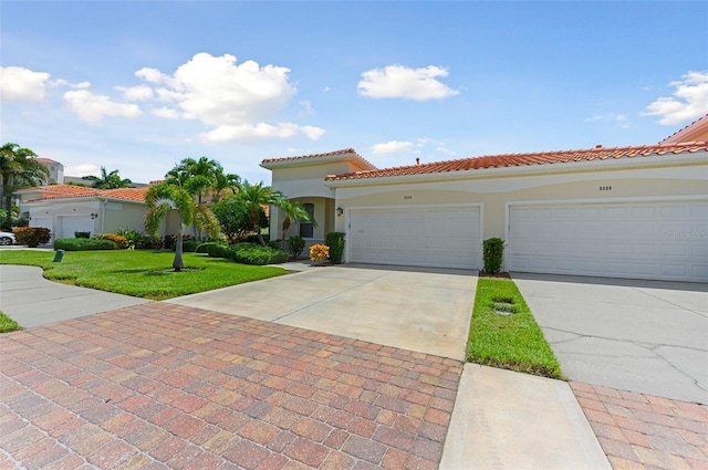 mediterranean / spanish-style home with a garage and a front yard