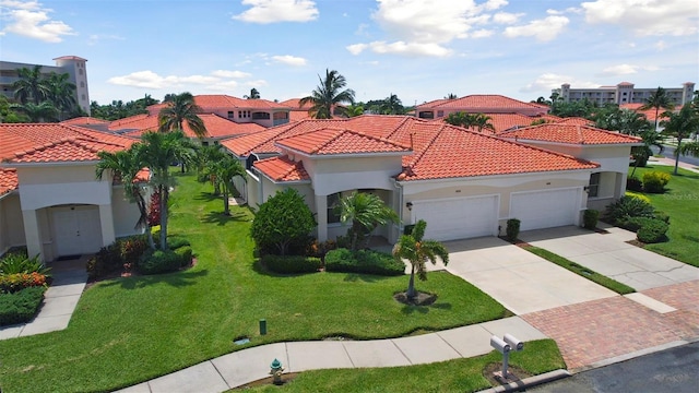 mediterranean / spanish home with a garage and a front lawn