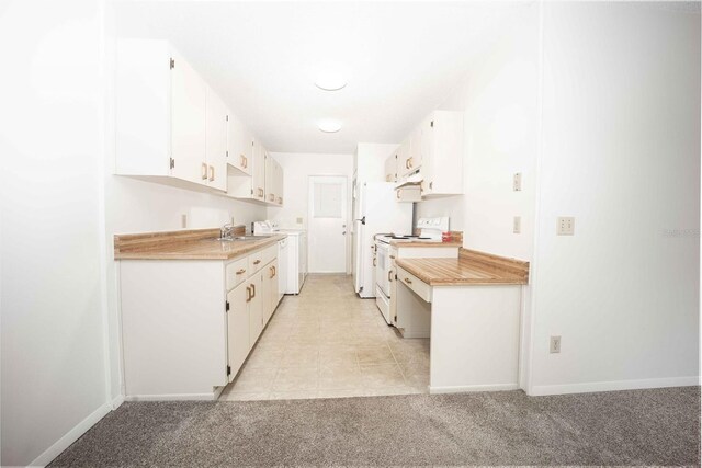 kitchen with electric range, white cabinetry, and light colored carpet