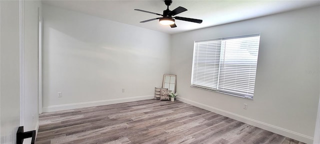 empty room with ceiling fan and light hardwood / wood-style flooring