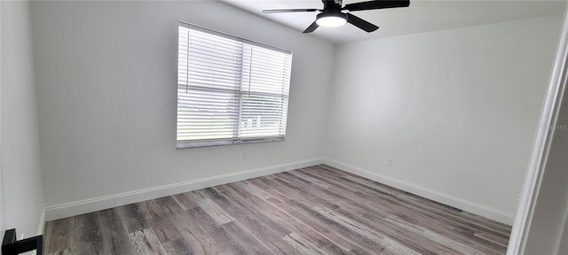 unfurnished room with ceiling fan and wood-type flooring