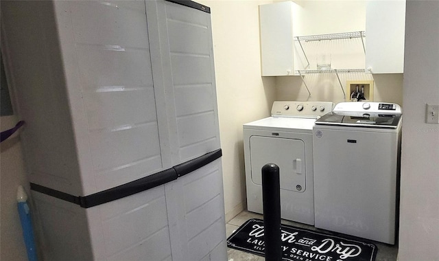 washroom featuring separate washer and dryer and light tile patterned flooring