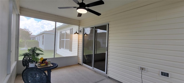 unfurnished sunroom featuring ceiling fan