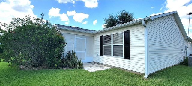 view of side of property with a yard