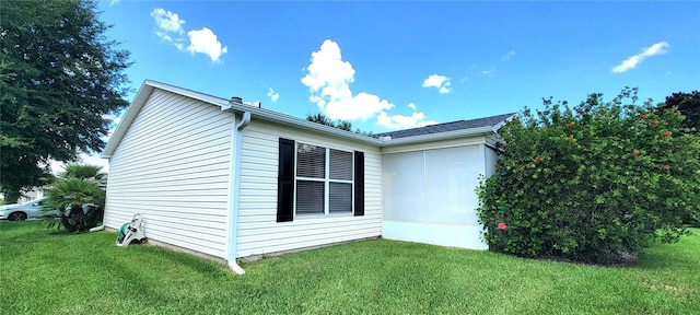 view of home's exterior with a yard