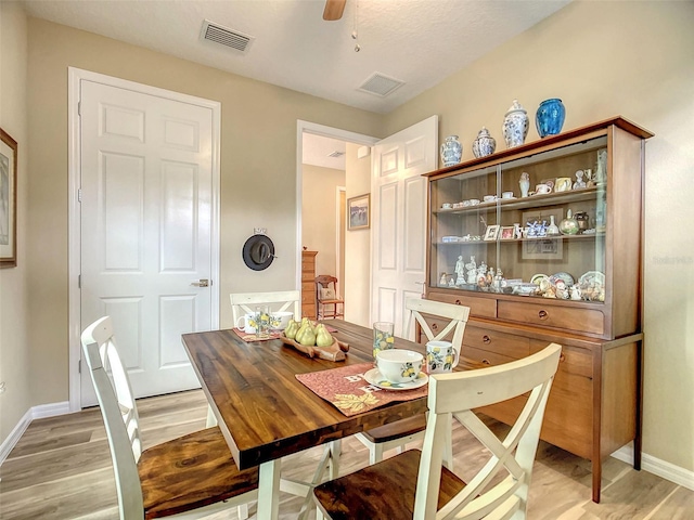 dining area with ceiling fan and light hardwood / wood-style flooring