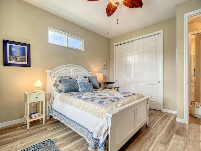 bedroom with light hardwood / wood-style flooring, a closet, and ceiling fan