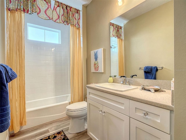 full bathroom with hardwood / wood-style flooring, shower / bath combo, toilet, and vanity