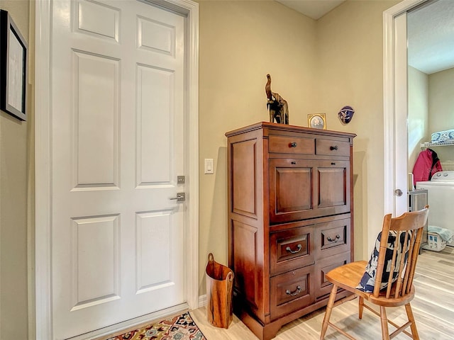 interior space with light hardwood / wood-style flooring and washer / clothes dryer