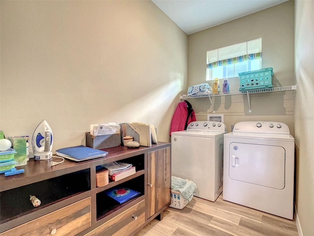 laundry area featuring washer and clothes dryer and light wood-type flooring